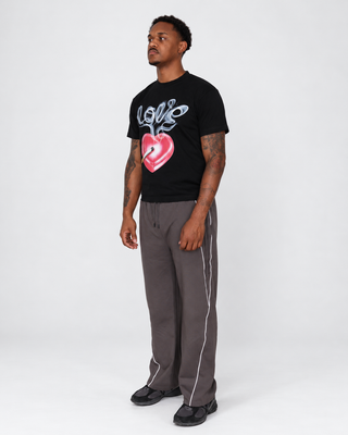 Model left three-quarter wearing Slow Burn tee and Reflection Stripe Sweats