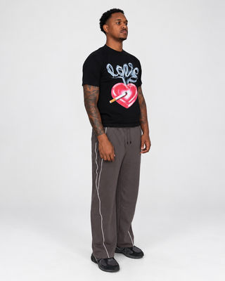 Model right three-quarter wearing Slow Burn tee and Reflection Stripe Sweats